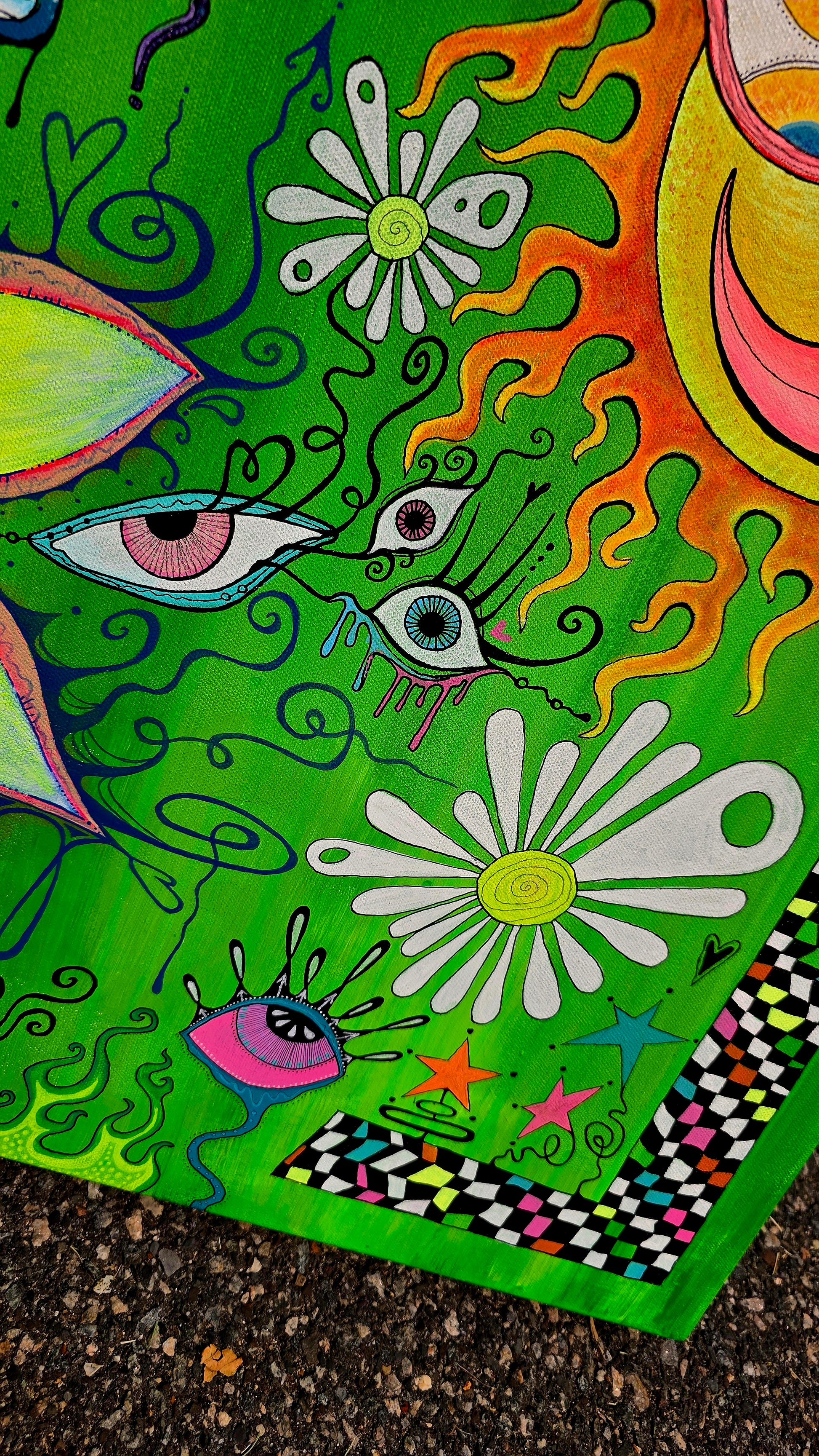 Colorful abstract artwork with eyes and flowers on a green background